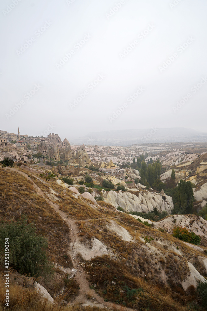 Natural landscape of Cappadocia, semi-arid region in central Turkey known for its distinctive fairy chimneys, tall cone-shaped rock formations clustered in Monks Valley, Göreme and elsewhere- Kayseri