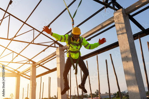 Construction workers fall from a height but have safety to help. Concept of preventing danger from heights with Safety on the construction site.