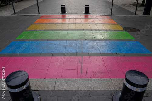 Fototapeta Naklejka Na Ścianę i Meble -  Pedestrian colors crossing street marking in LGBT colorful rainbow floor of lesbian gay flag in Bordeaux France