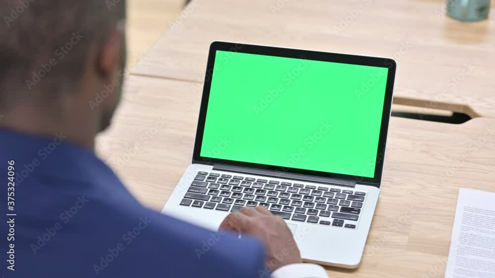 African Man Scrolling Laptop with Chroma Screen African Man Scrolling Laptop with Chroma Screen