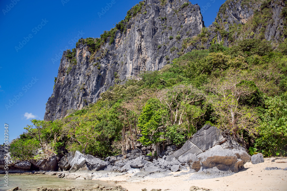 Wild beautiful beach on a small island with karst rocks in the Indian Ocean near El Nido, Palawan, Philippines