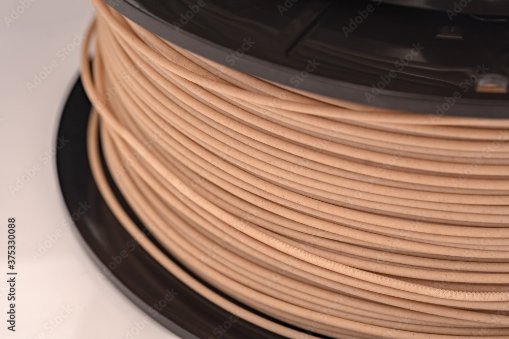 Spool of PLA filament for 3D Printer - wooden color. - obrazy, fototapety, plakaty 