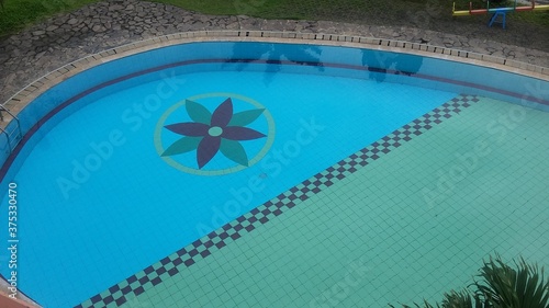 Swimming pool water surface in the sunlight texture background and wallpaper