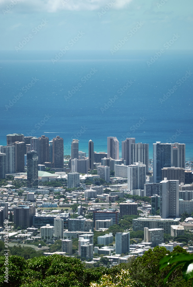 Cityscape of Honolulu city in Hawaii. Hotels and ocean in the morning.