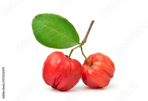 Organic acerola cherry with green leaves isolated on white background. Clipping path.