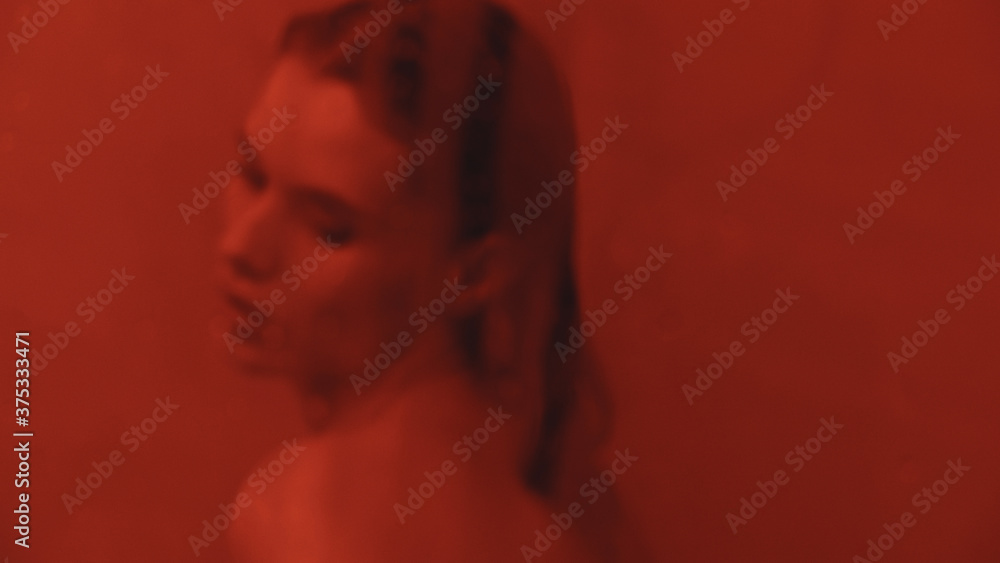Portrait of sexy girl flirting in bathroom. Wet woman cleaning mirror in bath. Portrait of sexy girl flirting in bathroom. Wet woman cleaning mirror in bath.