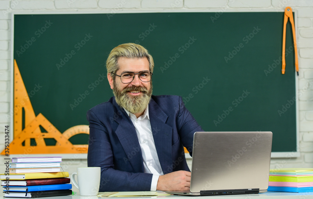 Teaching profession. Happy school teacher. Bearded man teach in class. Private teaching. Teaching and learning. Pedagogy. Pedagogical techniques. School and education Teaching profession. Happy school teacher. Bearded man teach in class. Private teaching. Teaching and learning. Pedagogy. Pedagogical techniques. School and education
