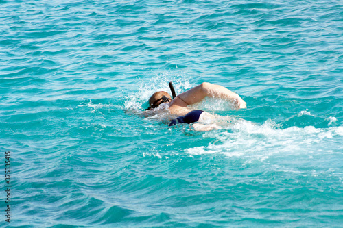 Man is swimming in the mediterranean sea