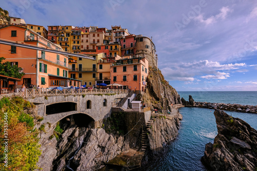 Colorful traditional houses on the rock over Mediterranean sea, Manarola, Cinque Terre, Italy