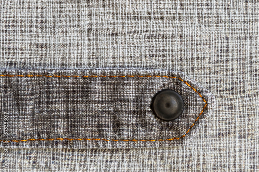 Linen fabric texture. Close-up. A fragment of linen cloth. Rough fabric texture. Double machine stitching on fabric. Decorative elements of trousers. Loose threads. A series of photographs. Flat lay Linen fabric texture. Close-up. A fragment of linen cloth. Rough fabric texture. Double machine stitching on fabric. Decorative elements of trousers. Loose threads. A series of photographs. Flat lay