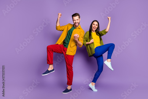 Full length body size view of his he her she nice attractive pretty lucky cheery glad ecstatic couple winners dancing rejoicing isolated bright vivid shine vibrant lilac violet purple color background