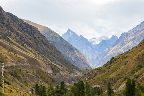 Mountain landscape with a river and a waterfall. Summer background. Belogorka gorge, Kyrgyzstan