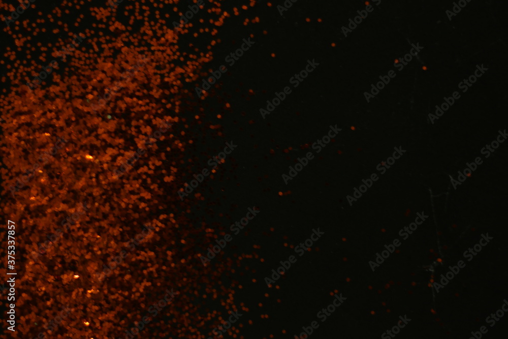 Abstract dark orange dots black background for texture
