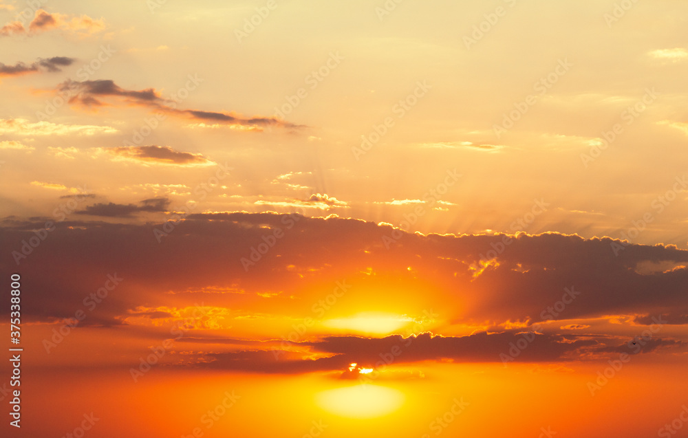 background of sunset sky, clouds lit by rays cover sun, beautiful landscape