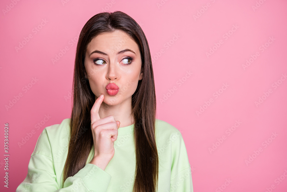 Closeup photo of funny attractive lady straight long hairdo sending air kisses flirty shy look empty space finger on chin wear casual green sweatshirt pullover isolated pink color background Closeup photo of funny attractive lady straight long hairdo sending air kisses flirty shy look empty space finger on chin wear casual green sweatshirt pullover isolated pink color background