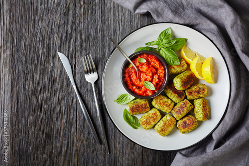 Obraz na płótnie baked broccoli tots on a plate with sauce