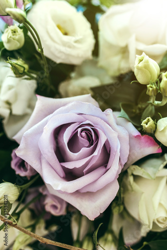 Vertical closeup floral decoration wedding bouquet. Fill the frame closeup with purple rose.