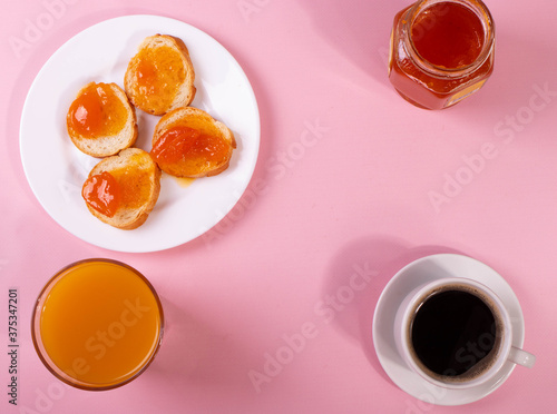 orange jam toasts and drink as breakfast concept