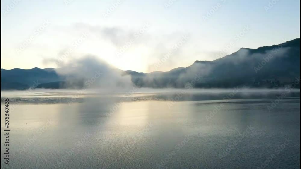 Lovely autumnal landscape with fog over the lake. Lovely autumnal landscape with fog over the lake.