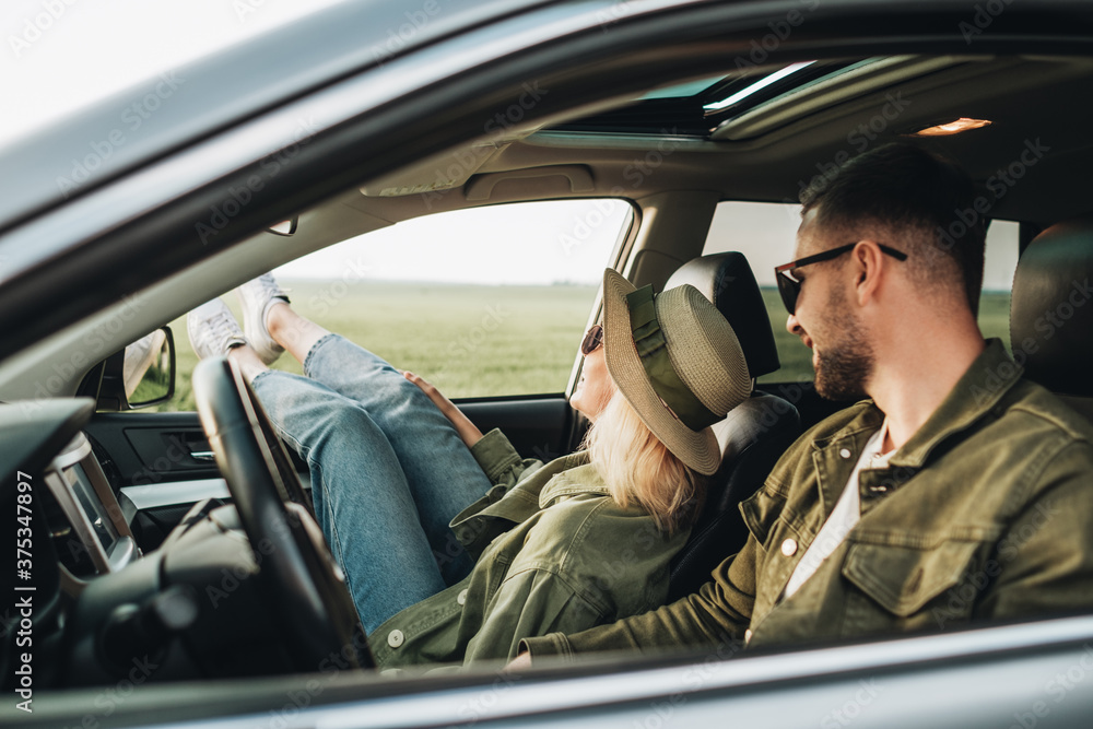 Man and Woman Sitting Inside Their Car, Having Fun and Enjoying Adventure Road Trip Man and Woman Sitting Inside Their Car, Having Fun and Enjoying Adventure Road Trip