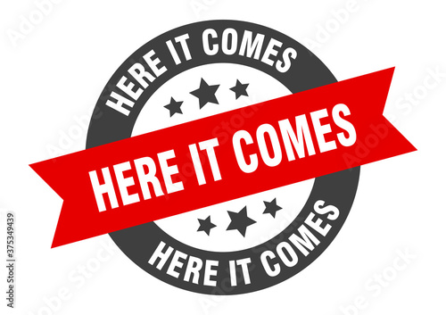 here it comes sign. round ribbon sticker. isolated tag