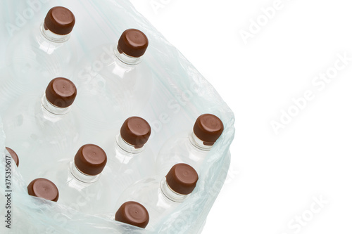 Garbage bag with empty transparent plastic bottles isolated on white background. Clipping path. Free copy space.