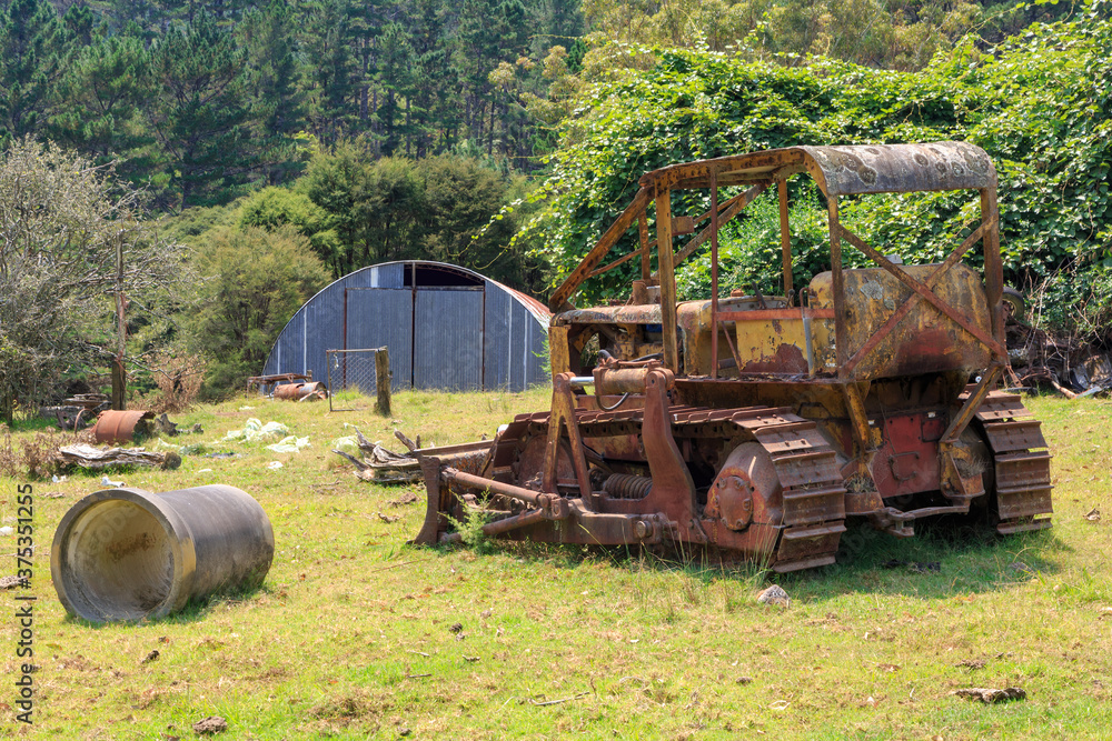 An old, abandoned bulldozer, rusting on a farm An old, abandoned bulldozer, rusting on a farm