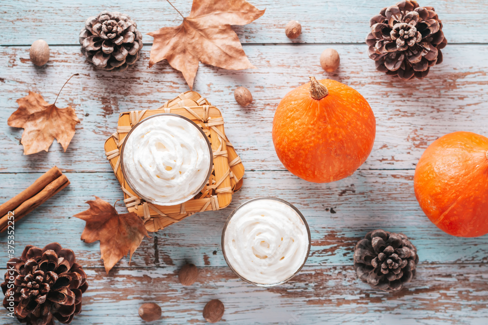 Autumn mood cozy flat lay with pumpkin latte, cedar pine cones, pumpkins and dried leaves on worn wood background, top view, fall, Thanksgiving background Autumn mood cozy flat lay with pumpkin latte, cedar pine cones, pumpkins and dried leaves on worn wood background, top view, fall, Thanksgiving background