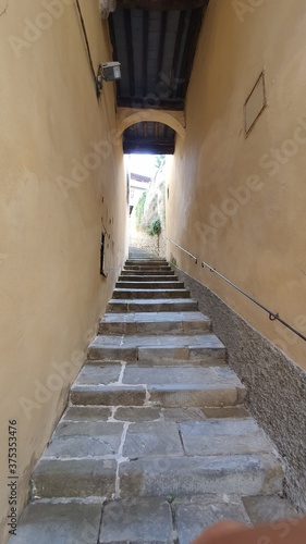 Decorated small alley in the centre of the historical town of Cortona, Arezzo, Italy. © Federico