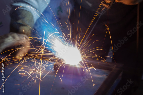 Metal welding. Sparks fly from the hot metal.