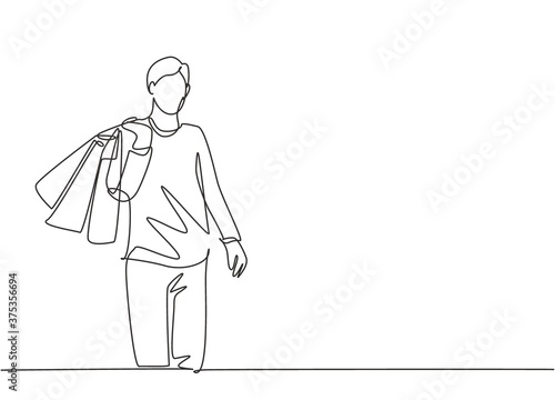 One single line drawing young happy attractive man holding paper bags after buying fashion and personal needs in mall. Commercial retail shopping concept. Continuous line draw design illustration