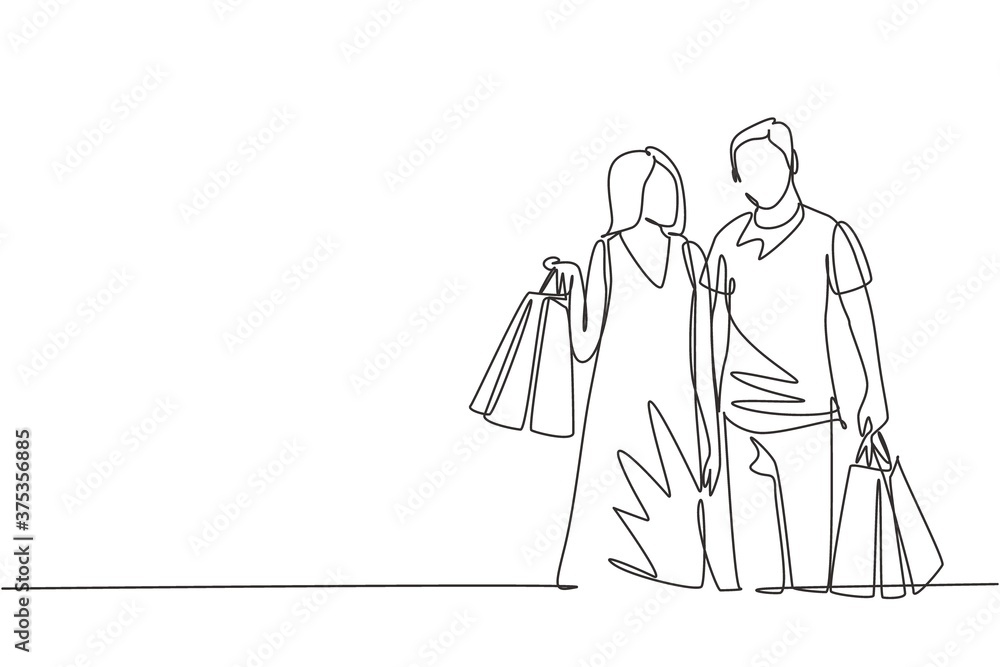 One single line drawing young happy romantic couple holding paper bags after buying dress and personal needs together at mall. Commercial shopping concept. Continuous line draw design illustration