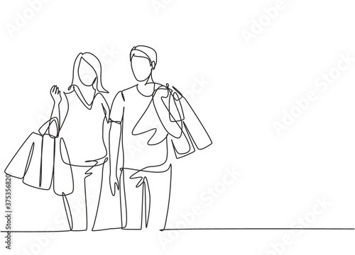 Single continuous line drawing young happy romantic couple holding paper bags while shopping together at mall. Buying fashion and cosmetic concept. One line draw vector graphic design illustration