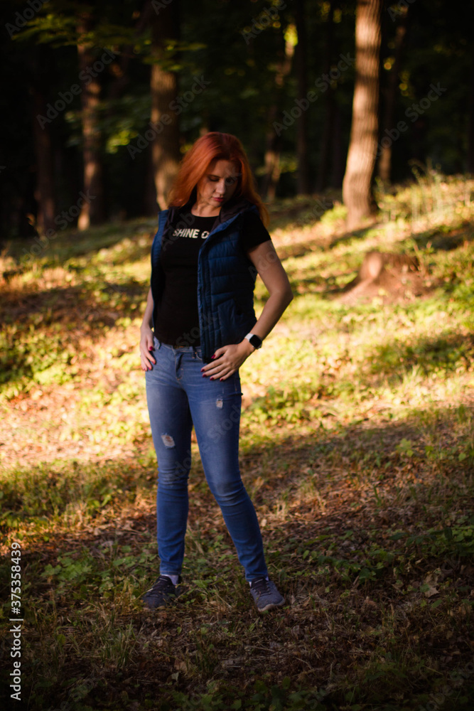 portrait of a young red-haired girl in the park portrait of a young red-haired girl in the park