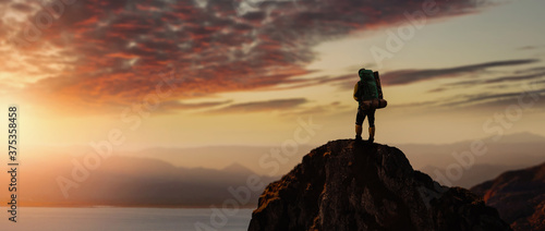 hiker men stand top of the mountain edge and enjoy incredible landscape.