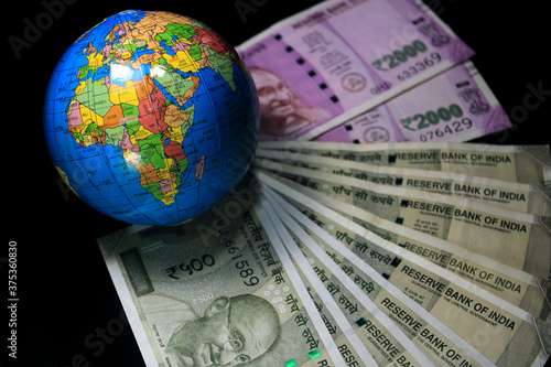 New Indian currency. 500  and 2000 rupee notes with globe. Indian currency isolated on black background.