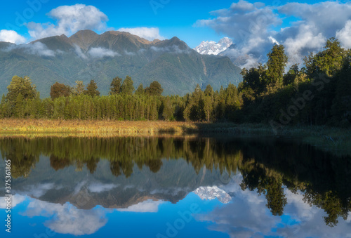 Fototapeta Naklejka Na Ścianę i Meble -  Reflections of Mount Cook and Mount Tasman in Lake Matheson, Fox Glacier New Zealand.