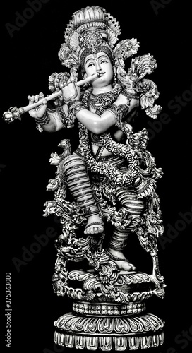 Beautiful Black and white BW Lord Krishna with Flute with a black background with fine carvings and artwork sculpture of thandava krishna