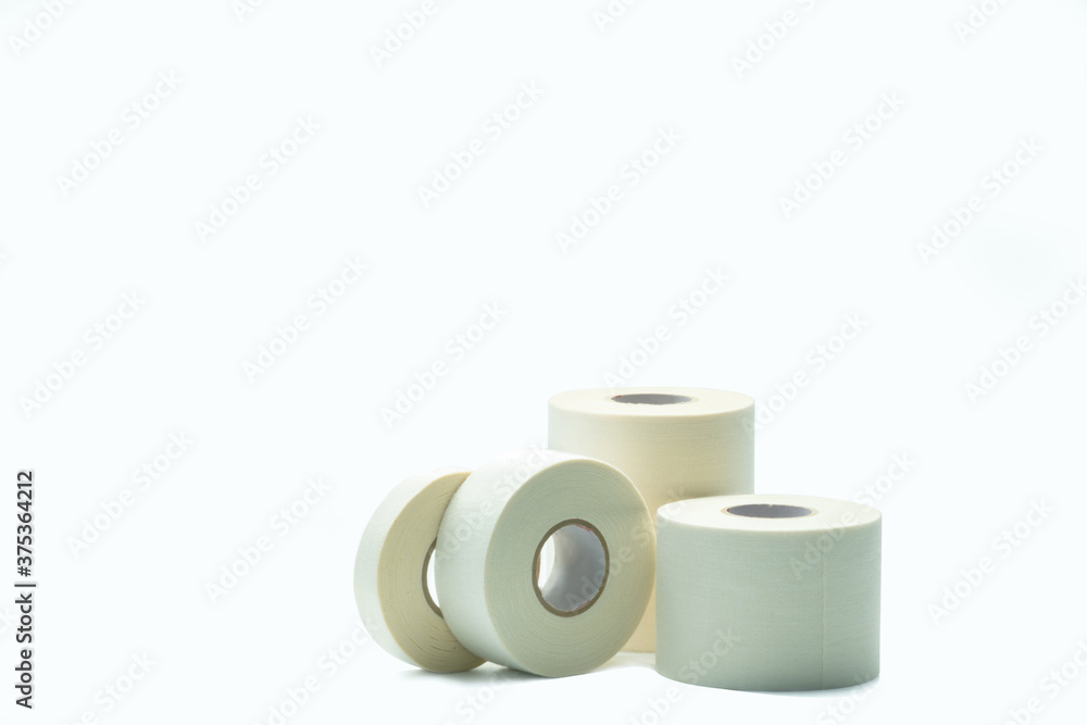White sport tape isolated on white background. Athletic taping. Porous adhesive tape. Medical tape. Multipurpose porous tape for wound care and sprain. First aid medical supplies. Sport bandage. White sport tape isolated on white background. Athletic taping. Porous adhesive tape. Medical tape. Multipurpose porous tape for wound care and sprain. First aid medical supplies. Sport bandage.