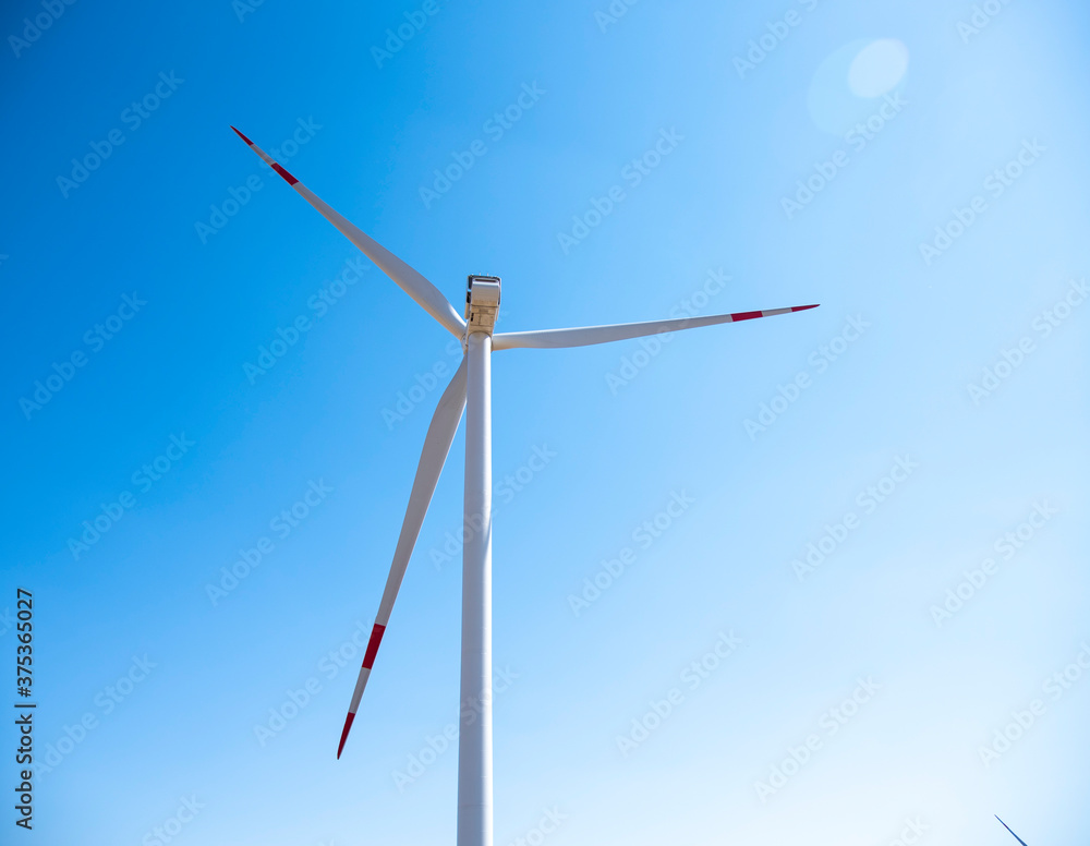 Fototapeta premium One windmill against a clear blue sky.