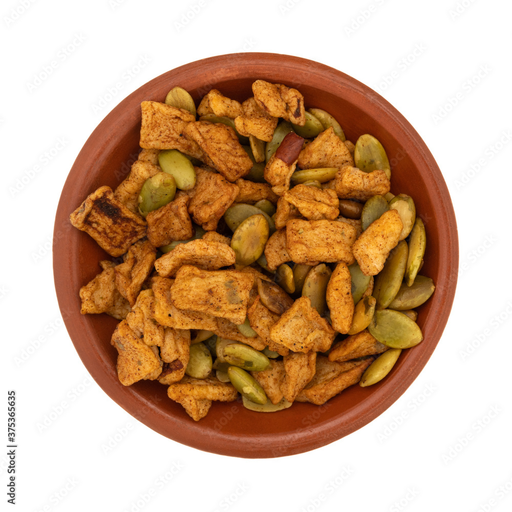 Small bowl filled with dried apple chunks with pumpkin seeds Small bowl filled with dried apple chunks with pumpkin seeds