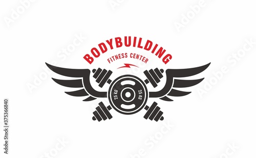 Crossed dumbbells, barbell, wings, text. Vector illustration advertises fitness center. Bodybuilding sports club logo. Color illustration in black and red on a white background. Sport equipment.