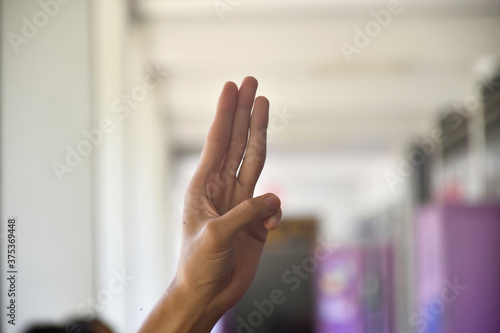 Human fingers with blurred background.