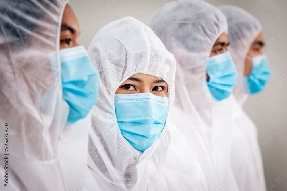 Team of Medical Research Scientists Working in PPE Suit. Team of Medical Research Scientists Working in PPE Suit.