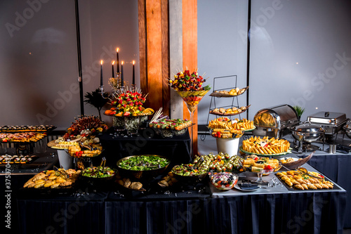 Catering banquet table with various snacks and appetizers with a sandwich