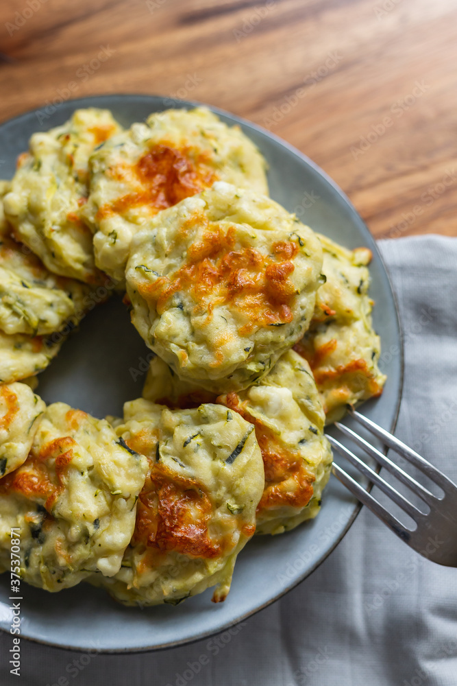 vegetarian Zucchini Fritters on a grey plate, grey background vegetarian Zucchini Fritters on a grey plate, grey background