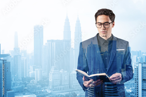 Photography Young handsome businessman in suit and glasses thinking how to tackle the problem, new career opportunities, MBA assignment