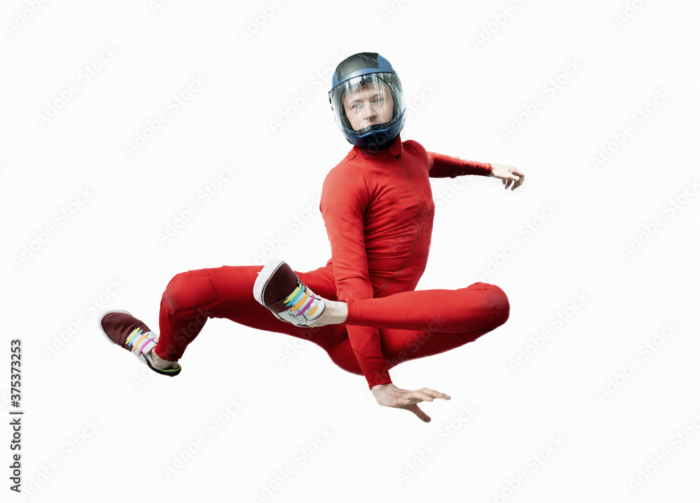 
levitation of athletes in a wind tunnel. jumping without a parachute in a wind tunnel indoors. Man in red suit, skydiver portrait isolated on white background