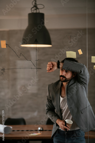 Businessman working on project. Tired businessman working in the office.