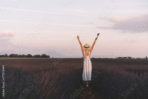 Joyful young woman enjoying freedom and lavender landscape